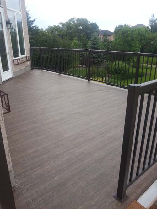 Steel railings and a faux-wood vinyl flooring for a deck addition project