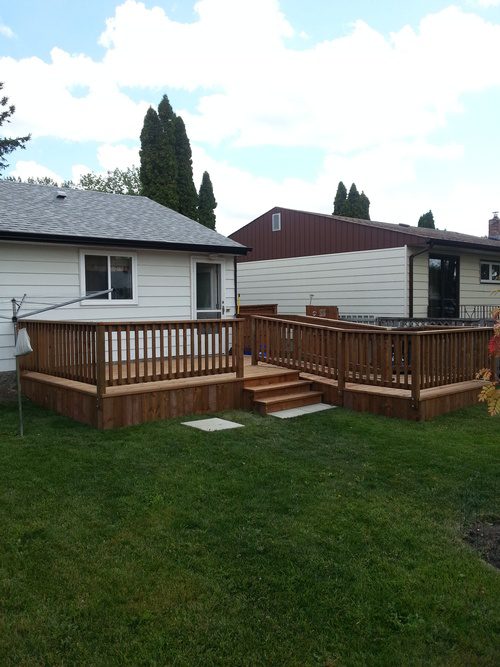 A fully-finished backyard wooden deck addition