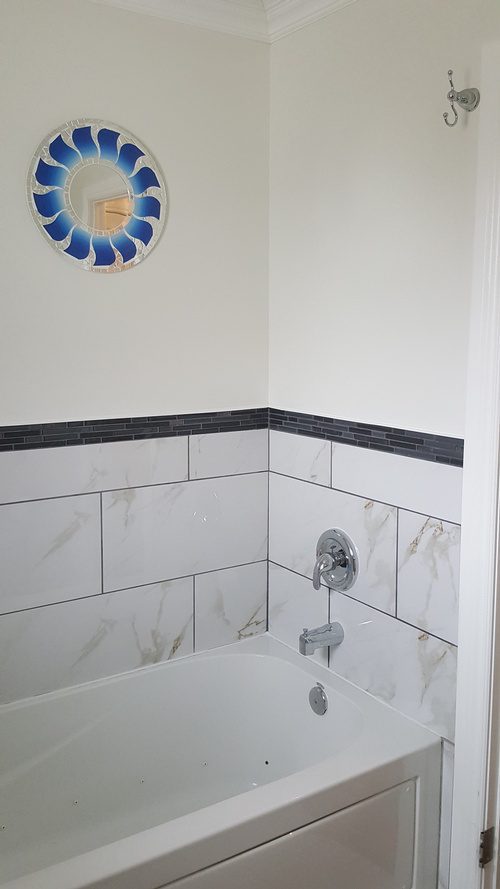 Marble-tiled walls for a shower area in a bathroom renovation project