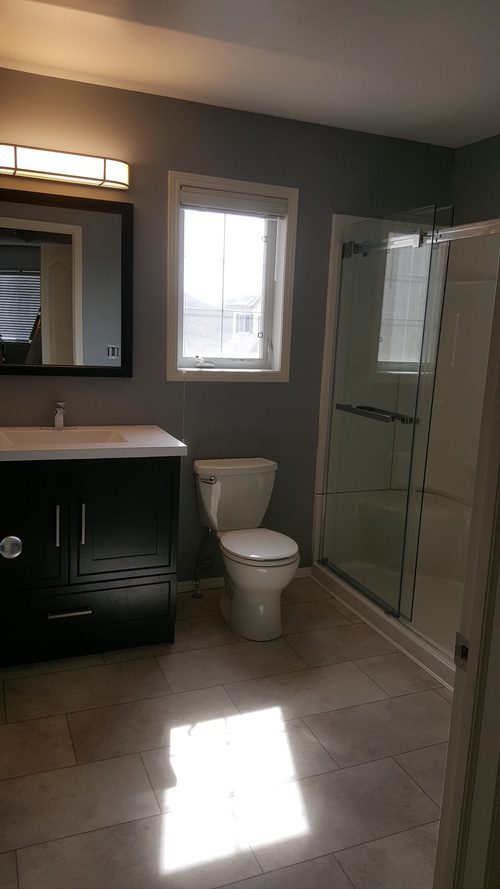 Stone flooring, new shower area, and new furnishings for a bathroom renovation project