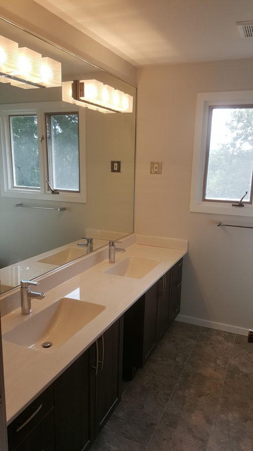 A wall-sized mirror and dual sinks for a bathroom renovation project