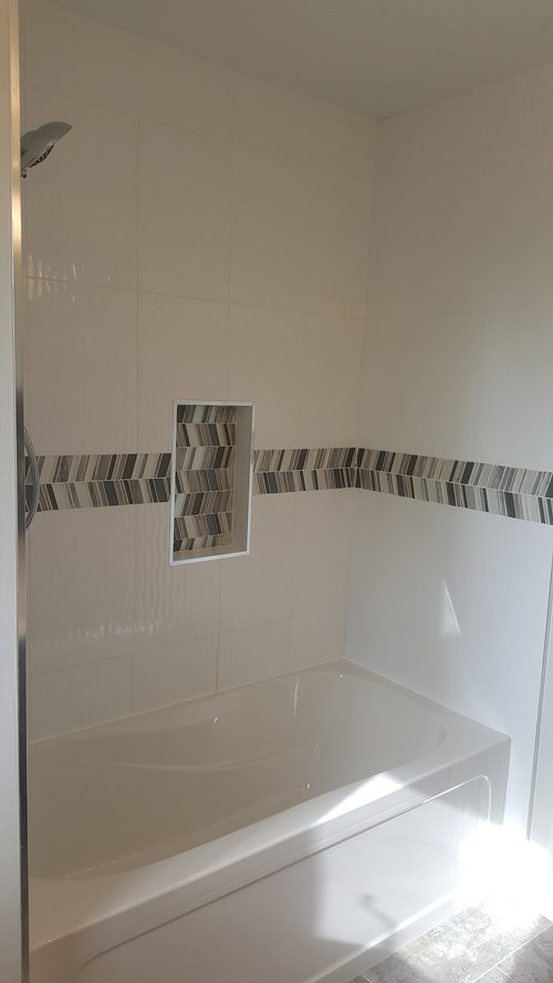 A tiled wall for the shower area in a bathroom renovation project