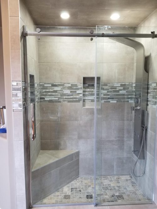 A modern showerhead and gray-tiled walls for a bathroom renovation project
