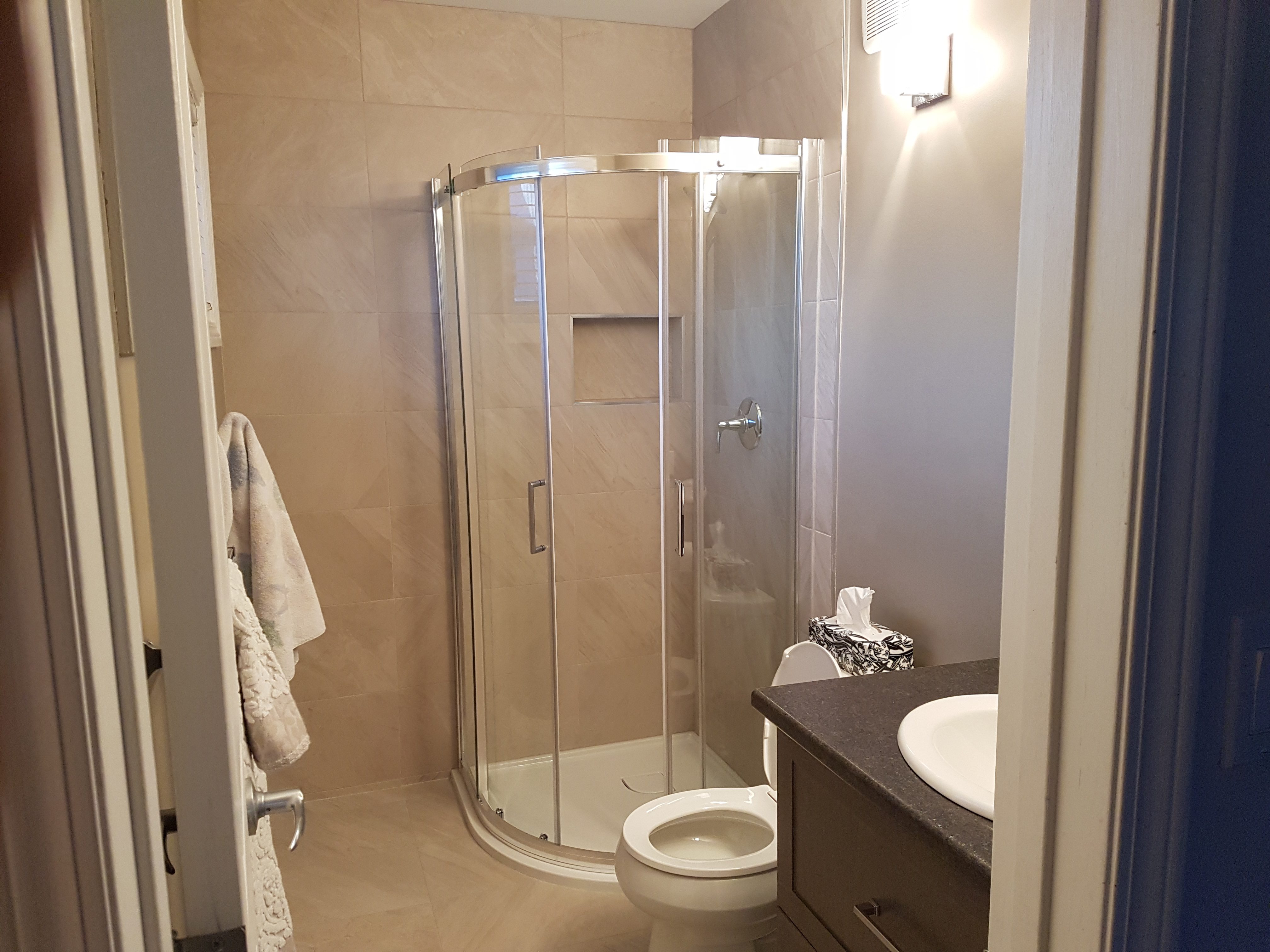 Bathroom renovation with a curved shower area