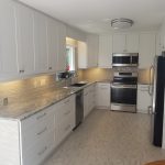 Marble countertops and brand new white cabinets for a kitchen renovation - Kitchen Renovations Winnipeg - Dash Builders